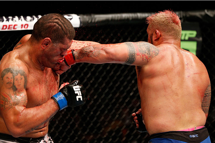BRISBANE, AUSTRALIA - DECEMBER 07: (R-L) Mark Hunt punches Antonio "Bigfoot" Silva in their heavyweight fight during the UFC Fight Night event at the Brisbane Entertainment Centre on December 7, 2013 in Brisbane, Australia. (Photo by Josh Hedges/Zuffa LL