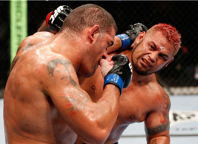 BRISBANE, AUSTRALIA - DECEMBER 07: (R-L) Mark Hunt punches Antonio "Bigfoot" Silva in their heavyweight fight during the UFC Fight Night event at the Brisbane Entertainment Centre on December 7, 2013 in Brisbane, Australia. (Photo by Josh Hedges/Zuffa LL