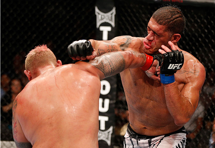 BRISBANE, AUSTRALIA - DECEMBER 07: (L-R) Mark Hunt punches Antonio "Bigfoot" Silva in their heavyweight fight during the UFC Fight Night event at the Brisbane Entertainment Centre on December 7, 2013 in Brisbane, Australia. (Photo by Josh Hedges/Zuffa LL