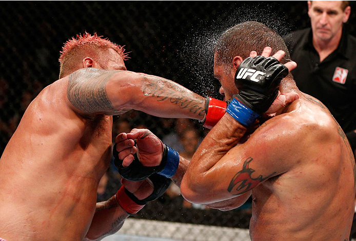 BRISBANE, AUSTRALIA - DECEMBER 07: (L-R) Mark Hunt punches Antonio "Bigfoot" Silva in their heavyweight fight during the UFC Fight Night event at the Brisbane Entertainment Centre on December 7, 2013 in Brisbane, Australia. (Photo by Josh Hedges/Zuffa LL