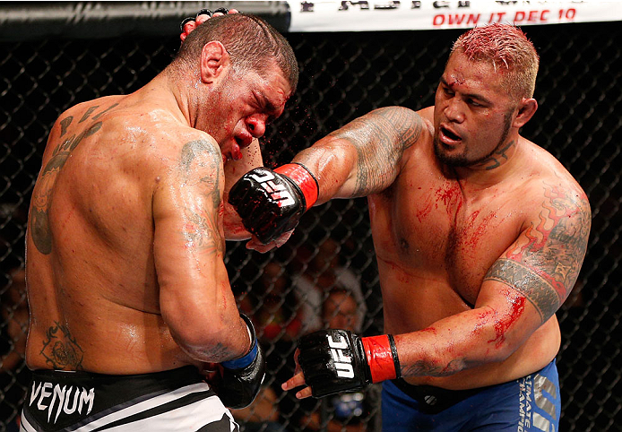 BRISBANE, AUSTRALIA - DECEMBER 07: (R-L) Mark Hunt punches Antonio "Bigfoot" Silva in their heavyweight fight during the UFC Fight Night event at the Brisbane Entertainment Centre on December 7, 2013 in Brisbane, Australia. (Photo by Josh Hedges/Zuffa LL