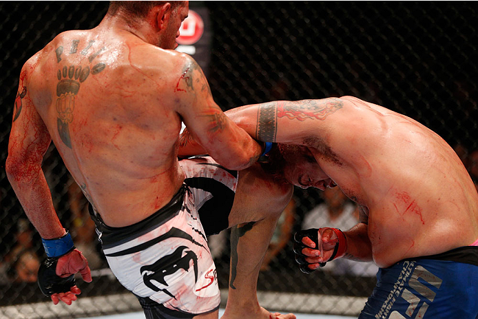 BRISBANE, AUSTRALIA - DECEMBER 07: (L-R) Antonio "Bigfoot" Silva knees Mark Hunt in their heavyweight fight during the UFC Fight Night event at the Brisbane Entertainment Centre on December 7, 2013 in Brisbane, Australia. (Photo by Josh Hedges/Zuffa LLC/