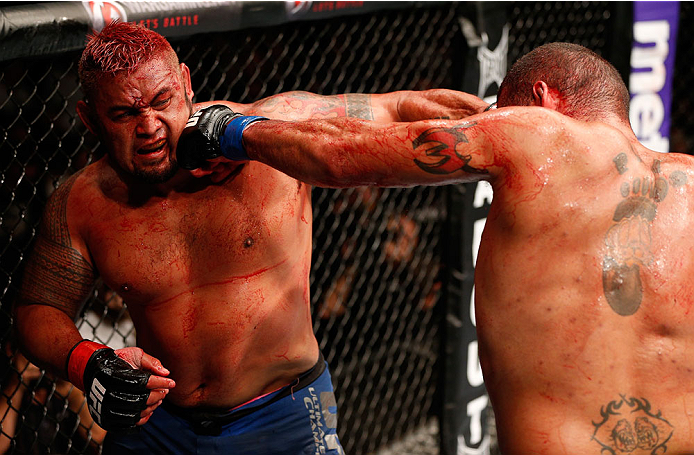 BRISBANE, AUSTRALIA - DECEMBER 07: (L-R) Mark Hunt and Antonio "Bigfoot" Silva trade punches in their heavyweight fight during the UFC Fight Night event at the Brisbane Entertainment Centre on December 7, 2013 in Brisbane, Australia. (Photo by Josh Hedge