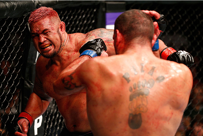 BRISBANE, AUSTRALIA - DECEMBER 07: (L-R) Mark Hunt punches Antonio "Bigfoot" Silva in their heavyweight fight during the UFC Fight Night event at the Brisbane Entertainment Centre on December 7, 2013 in Brisbane, Australia. (Photo by Josh Hedges/Zuffa LL