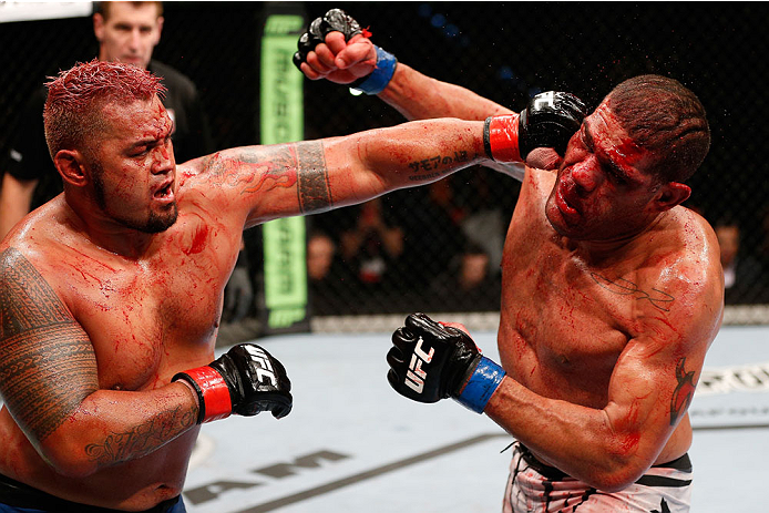 BRISBANE, AUSTRALIA - DECEMBER 07: (L-R) Mark Hunt punches Antonio "Bigfoot" Silva in their heavyweight fight during the UFC Fight Night event at the Brisbane Entertainment Centre on December 7, 2013 in Brisbane, Australia. (Photo by Josh Hedges/Zuffa LL