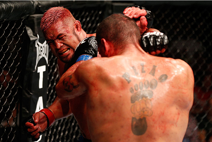 BRISBANE, AUSTRALIA - DECEMBER 07: (L-R) Mark Hunt punches Antonio "Bigfoot" Silva in their heavyweight fight during the UFC Fight Night event at the Brisbane Entertainment Centre on December 7, 2013 in Brisbane, Australia. (Photo by Josh Hedges/Zuffa LL