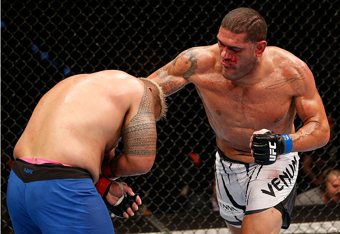 BRISBANE, AUSTRALIA - DECEMBER 07: (R-L) Antonio "Bigfoot" Silva punches Mark Hunt in their heavyweight fight during the UFC Fight Night event at the Brisbane Entertainment Centre on December 7, 2013 in Brisbane, Australia. (Photo by Josh Hedges/Zuffa LL