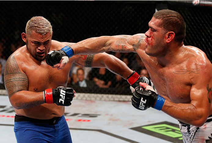 BRISBANE, AUSTRALIA - DECEMBER 07: (R-L) Antonio "Bigfoot" Silva punches Mark Hunt in their heavyweight fight during the UFC Fight Night event at the Brisbane Entertainment Centre on December 7, 2013 in Brisbane, Australia. (Photo by Josh Hedges/Zuffa LL