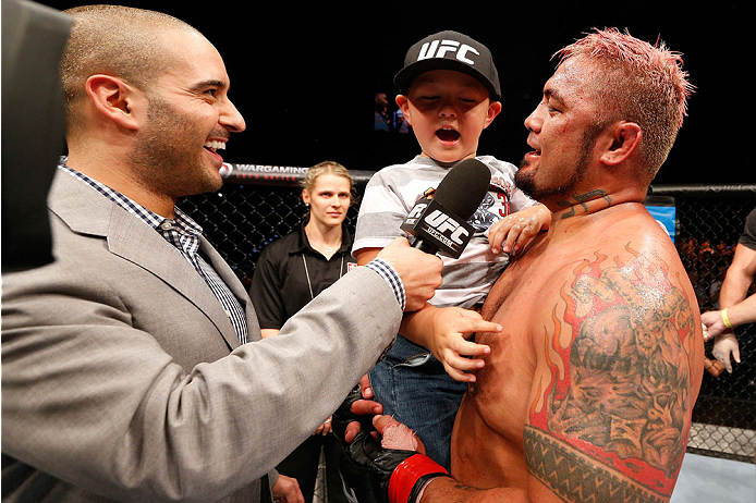 BRISBANE, AUSTRALIA - DECEMBER 07: Mark Hunt (R) is interviewed by Jon Anik with his son after his five-round heavyweight fight against Antonio "Bigfoot" Silva during the UFC Fight Night event at the Brisbane Entertainment Centre on December 7, 2013 in B
