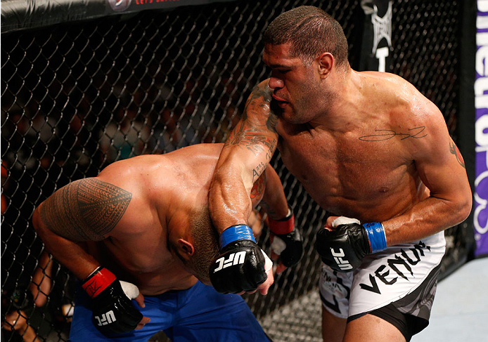 BRISBANE, AUSTRALIA - DECEMBER 07: (R-L) Antonio "Bigfoot" Silva punches Mark Hunt in their heavyweight fight during the UFC Fight Night event at the Brisbane Entertainment Centre on December 7, 2013 in Brisbane, Australia. (Photo by Josh Hedges/Zuffa LL