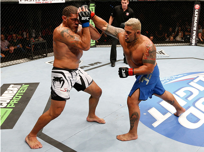 BRISBANE, AUSTRALIA - DECEMBER 07: (R-L) Mark Hunt punches Antonio "Bigfoot" Silva in their heavyweight fight during the UFC Fight Night event at the Brisbane Entertainment Centre on December 7, 2013 in Brisbane, Australia. (Photo by Josh Hedges/Zuffa LL