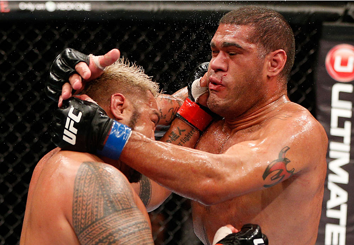 BRISBANE, AUSTRALIA - DECEMBER 07: (L-R) Mark Hunt punches Antonio "Bigfoot" Silva in their heavyweight fight during the UFC Fight Night event at the Brisbane Entertainment Centre on December 7, 2013 in Brisbane, Australia. (Photo by Josh Hedges/Zuffa LL