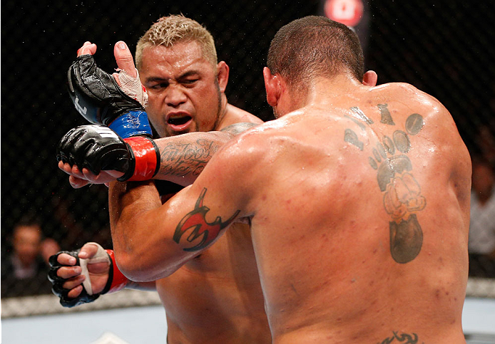 BRISBANE, AUSTRALIA - DECEMBER 07: (L-R) Mark Hunt punches Antonio "Bigfoot" Silva in their heavyweight fight during the UFC Fight Night event at the Brisbane Entertainment Centre on December 7, 2013 in Brisbane, Australia. (Photo by Josh Hedges/Zuffa LL