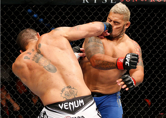 BRISBANE, AUSTRALIA - DECEMBER 07: (L-R) Antonio "Bigfoot" Silva knocks down Mark Hunt with a punch in the first round of their heavyweight fight during the UFC Fight Night event at the Brisbane Entertainment Centre on December 7, 2013 in Brisbane, Austr