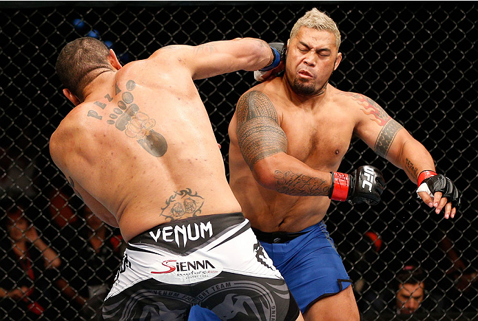BRISBANE, AUSTRALIA - DECEMBER 07: (L-R) Antonio "Bigfoot" Silva knocks down Mark Hunt with a punch in the first round of their heavyweight fight during the UFC Fight Night event at the Brisbane Entertainment Centre on December 7, 2013 in Brisbane, Austr