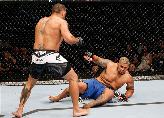 BRISBANE, AUSTRALIA - DECEMBER 07: (L-R) Antonio "Bigfoot" Silva knocks down Mark Hunt with a punch in the first round of their heavyweight fight during the UFC Fight Night event at the Brisbane Entertainment Centre on December 7, 2013 in Brisbane, Austr
