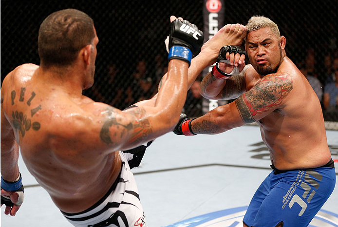 BRISBANE, AUSTRALIA - DECEMBER 07: (L-R) Antonio "Bigfoot" Silva kicks Mark Hunt in their heavyweight fight during the UFC Fight Night event at the Brisbane Entertainment Centre on December 7, 2013 in Brisbane, Australia. (Photo by Josh Hedges/Zuffa LLC/