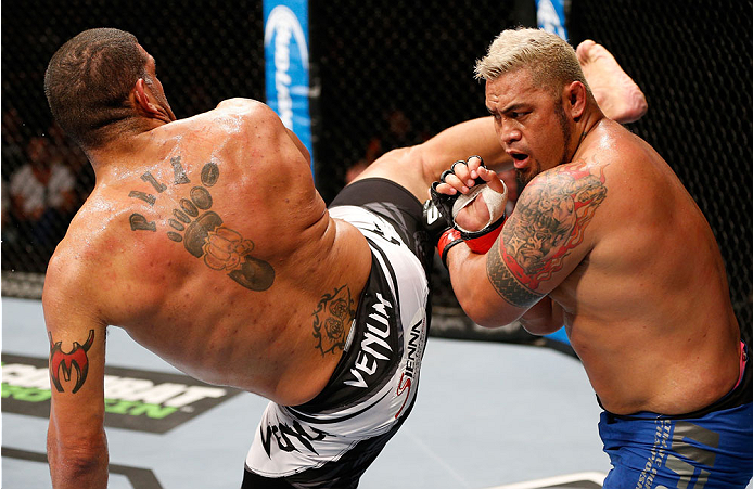 BRISBANE, AUSTRALIA - DECEMBER 07: (L-R) Antonio "Bigfoot" Silva kicks Mark Hunt in their heavyweight fight during the UFC Fight Night event at the Brisbane Entertainment Centre on December 7, 2013 in Brisbane, Australia. (Photo by Josh Hedges/Zuffa LLC/