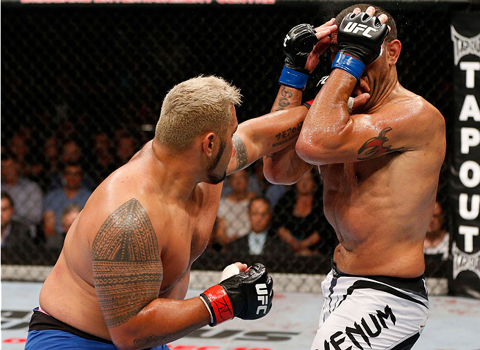 BRISBANE, AUSTRALIA - DECEMBER 07: (L-R) Mark Hunt punches Antonio "Bigfoot" Silva in their heavyweight fight during the UFC Fight Night event at the Brisbane Entertainment Centre on December 7, 2013 in Brisbane, Australia. (Photo by Josh Hedges/Zuffa LL