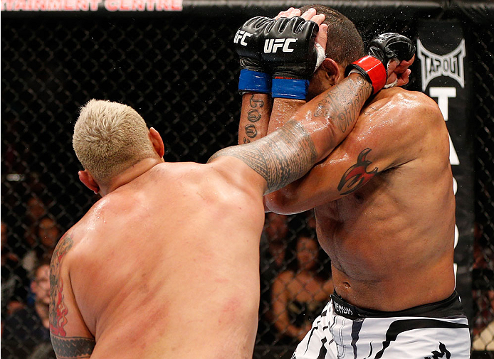 BRISBANE, AUSTRALIA - DECEMBER 07: (L-R) Mark Hunt punches Antonio "Bigfoot" Silva in their heavyweight fight during the UFC Fight Night event at the Brisbane Entertainment Centre on December 7, 2013 in Brisbane, Australia. (Photo by Josh Hedges/Zuffa LL
