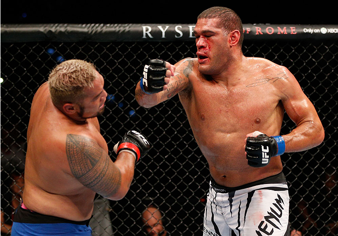 BRISBANE, AUSTRALIA - DECEMBER 07: (R-L) Antonio "Bigfoot" Silva punches Mark Hunt in their heavyweight fight during the UFC Fight Night event at the Brisbane Entertainment Centre on December 7, 2013 in Brisbane, Australia. (Photo by Josh Hedges/Zuffa LL