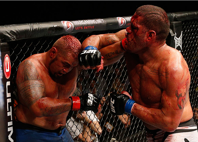 BRISBANE, AUSTRALIA - DECEMBER 07: (R-L) Antonio "Bigfoot" Silva punches Mark Hunt in their heavyweight fight during the UFC Fight Night event at the Brisbane Entertainment Centre on December 7, 2013 in Brisbane, Australia. (Photo by Josh Hedges/Zuffa LL