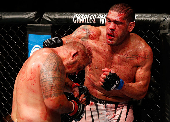 BRISBANE, AUSTRALIA - DECEMBER 07: (R-L) Antonio "Bigfoot" Silva punches Mark Hunt in their heavyweight fight during the UFC Fight Night event at the Brisbane Entertainment Centre on December 7, 2013 in Brisbane, Australia. (Photo by Josh Hedges/Zuffa LL