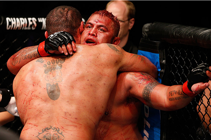 BRISBANE, AUSTRALIA - DECEMBER 07: (R-L) Opponents Mark Hunt and Antonio Silva hug after their five round battle during the UFC Fight Night event at the Brisbane Entertainment Centre on December 7, 2013 in Brisbane, Australia. (Photo by Josh Hedges/Zuffa