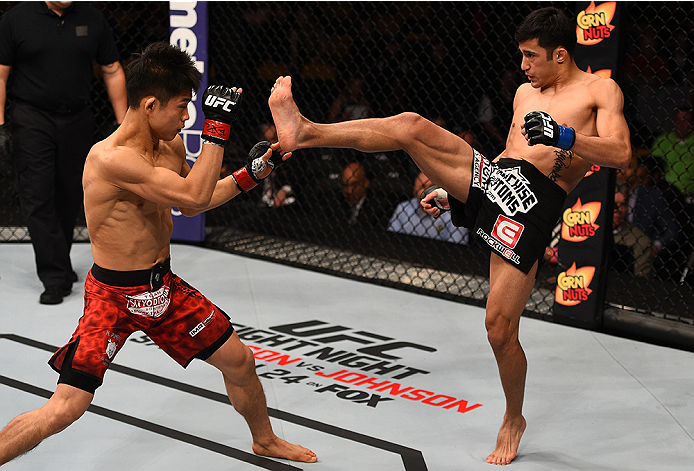 BOSTON, MA - JANUARY 18:  (R-L) Joby Sanchez kicks Tateki Matsuda in their flyweight fight during the UFC Fight Night event at the TD Garden on January 18, 2015 in Boston, Massachusetts. (Photo by Jeff Bottari/Zuffa LLC/Zuffa LLC via Getty Images)