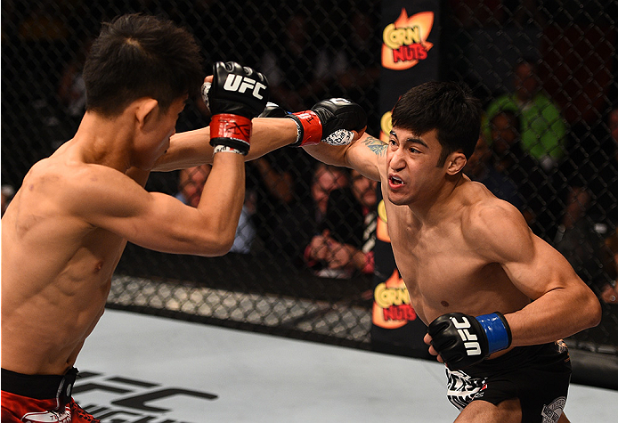 BOSTON, MA - JANUARY 18:  Joby Sanchez punches Tateki Matsuda in their flyweight fight during the UFC Fight Night event at the TD Garden on January 18, 2015 in Boston, Massachusetts. (Photo by Jeff Bottari/Zuffa LLC/Zuffa LLC via Getty Images)