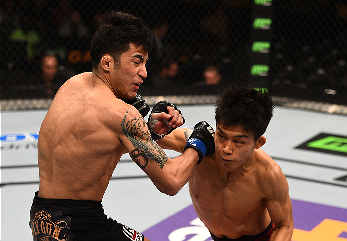 BOSTON, MA - JANUARY 18:  (R-L) Tateki Matsuda punches Joby Sanchez in their flyweight fight during the UFC Fight Night event at the TD Garden on January 18, 2015 in Boston, Massachusetts. (Photo by Jeff Bottari/Zuffa LLC/Zuffa LLC via Getty Images)