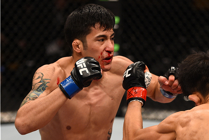 BOSTON, MA - JANUARY 18:  Joby Sanchez punches Tateki Matsuda in their flyweight fight during the UFC Fight Night event at the TD Garden on January 18, 2015 in Boston, Massachusetts. (Photo by Jeff Bottari/Zuffa LLC/Zuffa LLC via Getty Images)