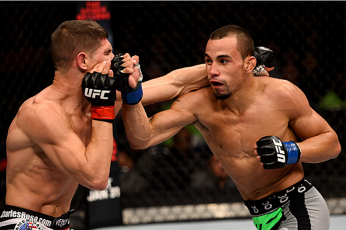 BOSTON, MA - JANUARY 18: (R-L) Sean Soriano punches Charles Rosa in their featherweight fight during the UFC Fight Night event at the TD Garden on January 18, 2015 in Boston, Massachusetts. (Photo by Jeff Bottari/Zuffa LLC/Zuffa LLC via Getty Images)