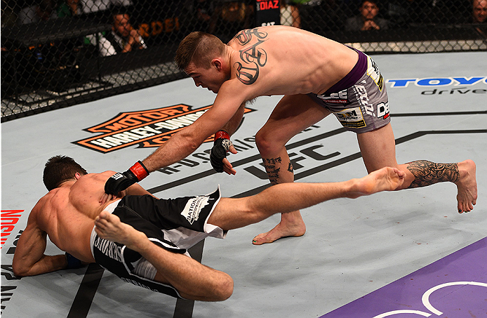 BOSTON, MA - JANUARY 18:  Johnny Case punches Frankie Perez in their lightweight fight during the UFC Fight Night event at the TD Garden on January 18, 2015 in Boston, Massachusetts. (Photo by Jeff Bottari/Zuffa LLC/Zuffa LLC via Getty Images)