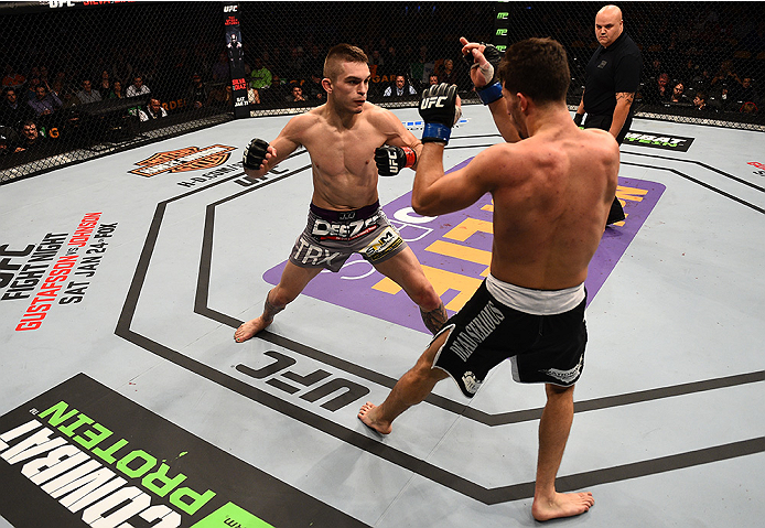 BOSTON, MA - JANUARY 18:  Johnny Case punches Frankie Perez in their lightweight fight during the UFC Fight Night event at the TD Garden on January 18, 2015 in Boston, Massachusetts. (Photo by Jeff Bottari/Zuffa LLC/Zuffa LLC via Getty Images)