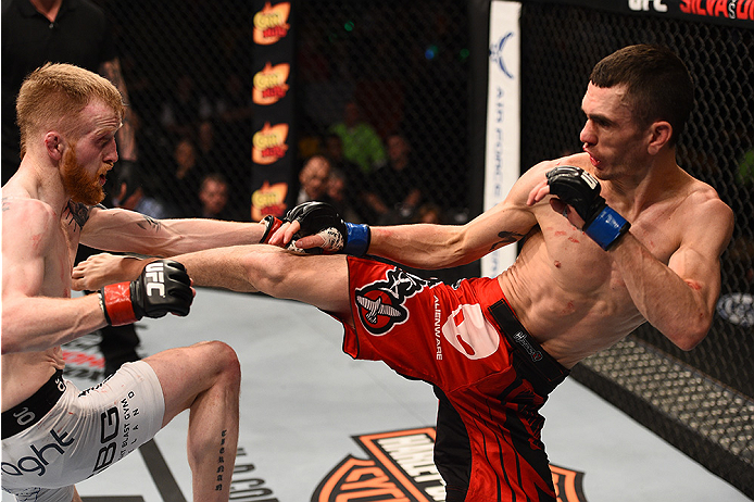 BOSTON, MA - JANUARY 18:  (R-L) Shane Howell kicks Paddy Holohan in their flyweight fight during the UFC Fight Night event at the TD Garden on January 18, 2015 in Boston, Massachusetts. (Photo by Jeff Bottari/Zuffa LLC/Zuffa LLC via Getty Images)