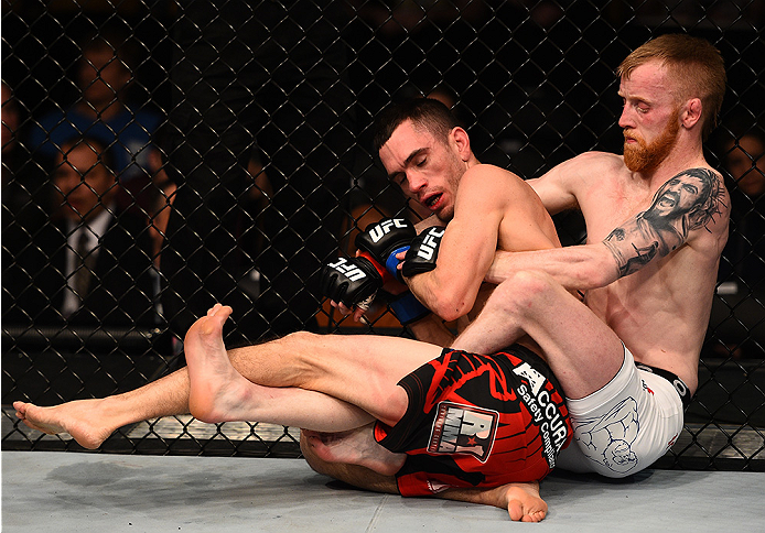 BOSTON, MA - JANUARY 18: (R-L) Paddy Holohan tackles Shane Howell in their flyweight fight during the UFC Fight Night event at the TD Garden on January 18, 2015 in Boston, Massachusetts. (Photo by Jeff Bottari/Zuffa LLC/Zuffa LLC via Getty Images)