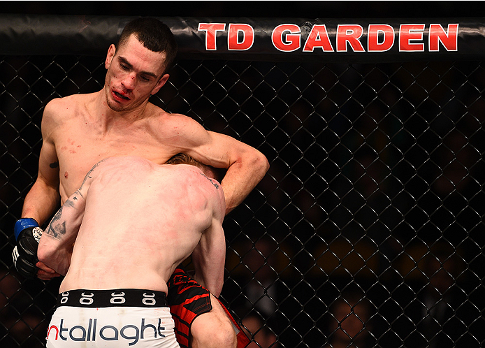 BOSTON, MA - JANUARY 18:  Paddy Holohan tackles Shane Howell in their flyweight fight during the UFC Fight Night event at the TD Garden on January 18, 2015 in Boston, Massachusetts. (Photo by Jeff Bottari/Zuffa LLC/Zuffa LLC via Getty Images)