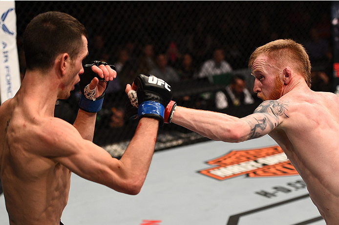 BOSTON, MA - JANUARY 18:  (R-L) Paddy Holohan punches Shane Howell in their flyweight fight during the UFC Fight Night event at the TD Garden on January 18, 2015 in Boston, Massachusetts. (Photo by Jeff Bottari/Zuffa LLC/Zuffa LLC via Getty Images)