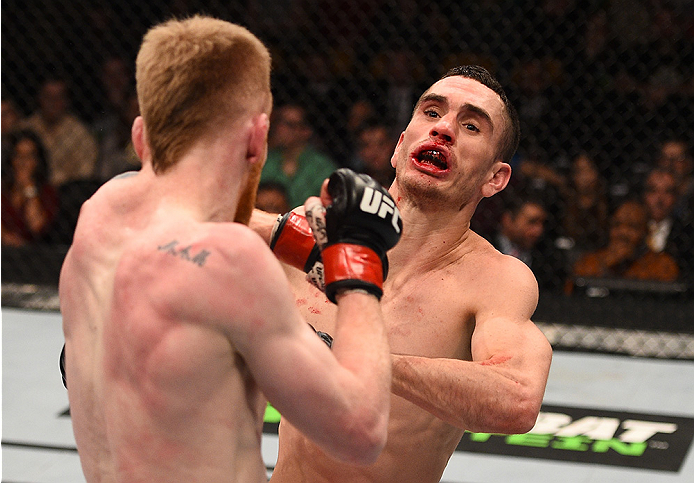 BOSTON, MA - JANUARY 18: (R-L) Shane Howell is punched by Paddy Holohan in their flyweight fight during the UFC Fight Night event at the TD Garden on January 18, 2015 in Boston, Massachusetts. (Photo by Jeff Bottari/Zuffa LLC/Zuffa LLC via Getty Images)