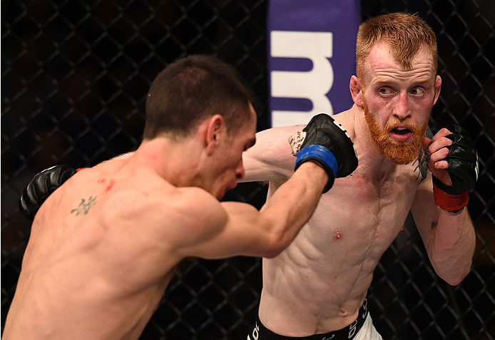 BOSTON, MA - JANUARY 18: (R-L) Paddy Holohan punches Shane Howell in their flyweight fight during the UFC Fight Night event at the TD Garden on January 18, 2015 in Boston, Massachusetts. (Photo by Jeff Bottari/Zuffa LLC/Zuffa LLC via Getty Images)