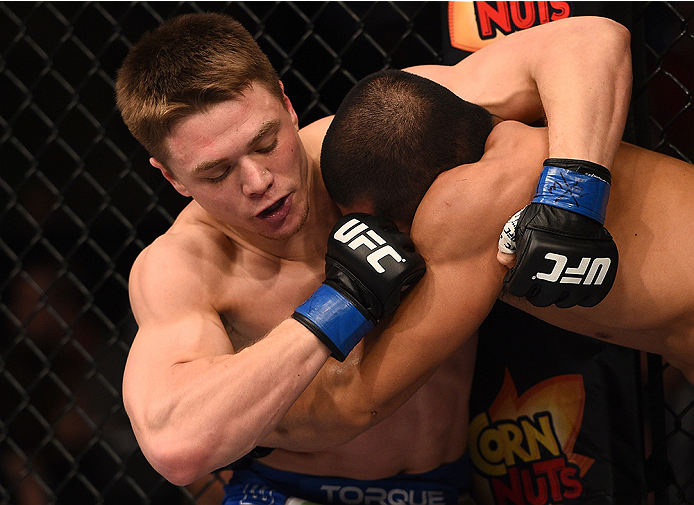 BOSTON, MA - JANUARY 18: (L-R) Chris Wade punches Zhang Lipeng in their lightweight fight during the UFC Fight Night event at the TD Garden on January 18, 2015 in Boston, Massachusetts. (Photo by Jeff Bottari/Zuffa LLC/Zuffa LLC via Getty Images)