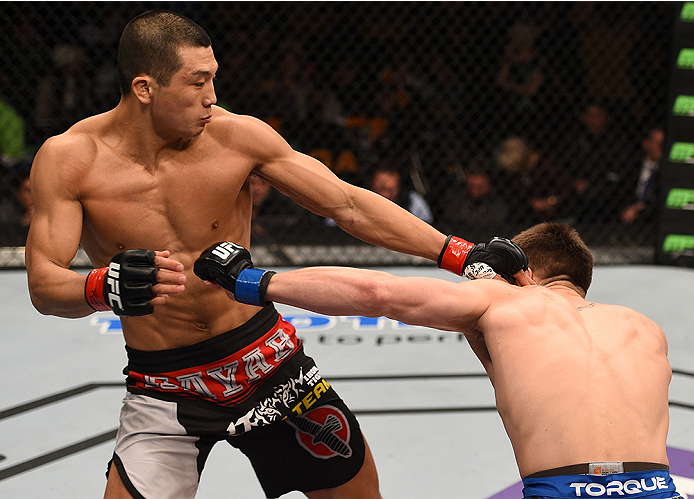 BOSTON, MA - JANUARY 18: (L-R) Zhang Lipeng punches Chris Wade in their lightweight fight during the UFC Fight Night event at the TD Garden on January 18, 2015 in Boston, Massachusetts. (Photo by Jeff Bottari/Zuffa LLC/Zuffa LLC via Getty Images)