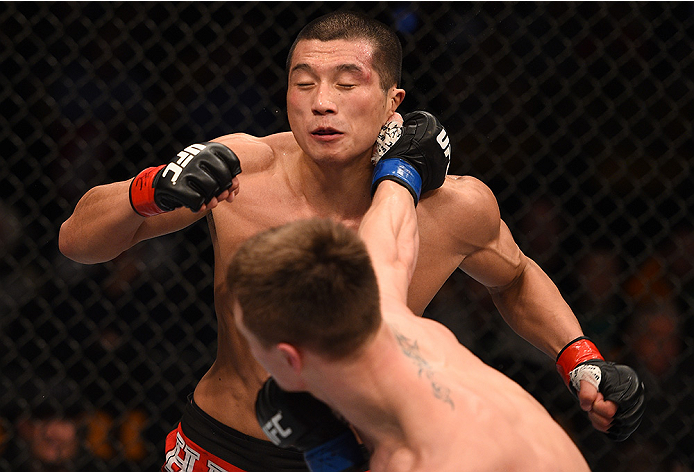 BOSTON, MA - JANUARY 18:  Chris Wade punches Zhang Lipeng in their lightweight fight during the UFC Fight Night event at the TD Garden on January 18, 2015 in Boston, Massachusetts. (Photo by Jeff Bottari/Zuffa LLC/Zuffa LLC via Getty Images)