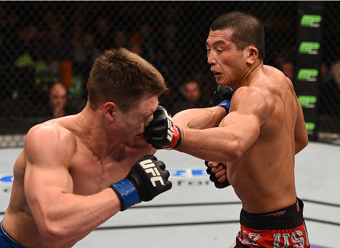 BOSTON, MA - JANUARY 18: (R-L) Zhang Lipeng punches Chris Wade in their lightweight fight during the UFC Fight Night event at the TD Garden on January 18, 2015 in Boston, Massachusetts. (Photo by Jeff Bottari/Zuffa LLC/Zuffa LLC via Getty Images)