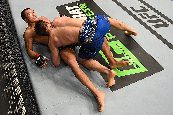 BOSTON, MA - JANUARY 18:  (R-L) Chris Wade tackles Zhang Lipeng in their lightweight fight during the UFC Fight Night event at the TD Garden on January 18, 2015 in Boston, Massachusetts. (Photo by Jeff Bottari/Zuffa LLC/Zuffa LLC via Getty Images)