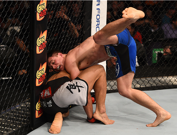 BOSTON, MA - JANUARY 18:  (R-L) Chris Wade tackles Zhang Lipeng in their lightweight fight during the UFC Fight Night event at the TD Garden on January 18, 2015 in Boston, Massachusetts. (Photo by Jeff Bottari/Zuffa LLC/Zuffa LLC via Getty Images)