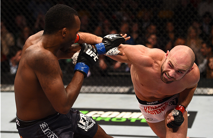 BOSTON, MA - JANUARY 18: (R-L) Cathal Pendred punches Sean Spencer in their welterweight fight during the UFC Fight Night event at the TD Garden on January 18, 2015 in Boston, Massachusetts. (Photo by Jeff Bottari/Zuffa LLC/Zuffa LLC via Getty Images)