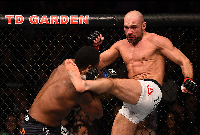 BOSTON, MA - JANUARY 18: (R-L) Cathal Pendred kicks Sean Spencer in their welterweight fight during the UFC Fight Night event at the TD Garden on January 18, 2015 in Boston, Massachusetts. (Photo by Jeff Bottari/Zuffa LLC/Zuffa LLC via Getty Images)