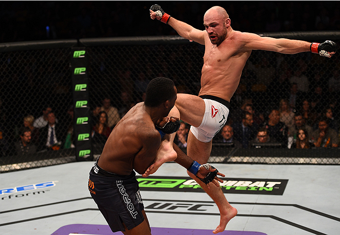 BOSTON, MA - JANUARY 18: (R-L) Cathal Pendred kicks Sean Spencer in their welterweight fight during the UFC Fight Night event at the TD Garden on January 18, 2015 in Boston, Massachusetts. (Photo by Jeff Bottari/Zuffa LLC/Zuffa LLC via Getty Images)